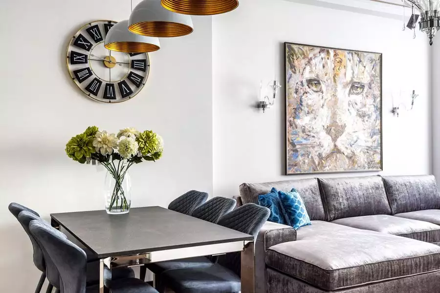 A large abstract leopard painting and a Roman numeral wall clock deliver eye catching Dining Wall Decor over a modern dining table