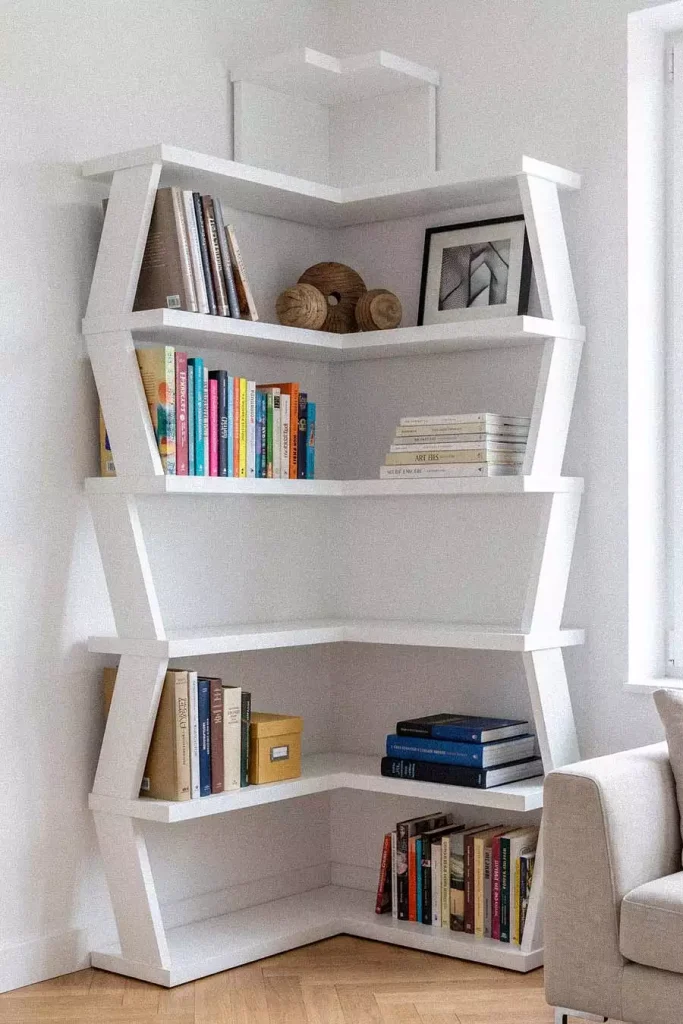 Angular White Wall Shelf Decor Stacked With Colorful Books