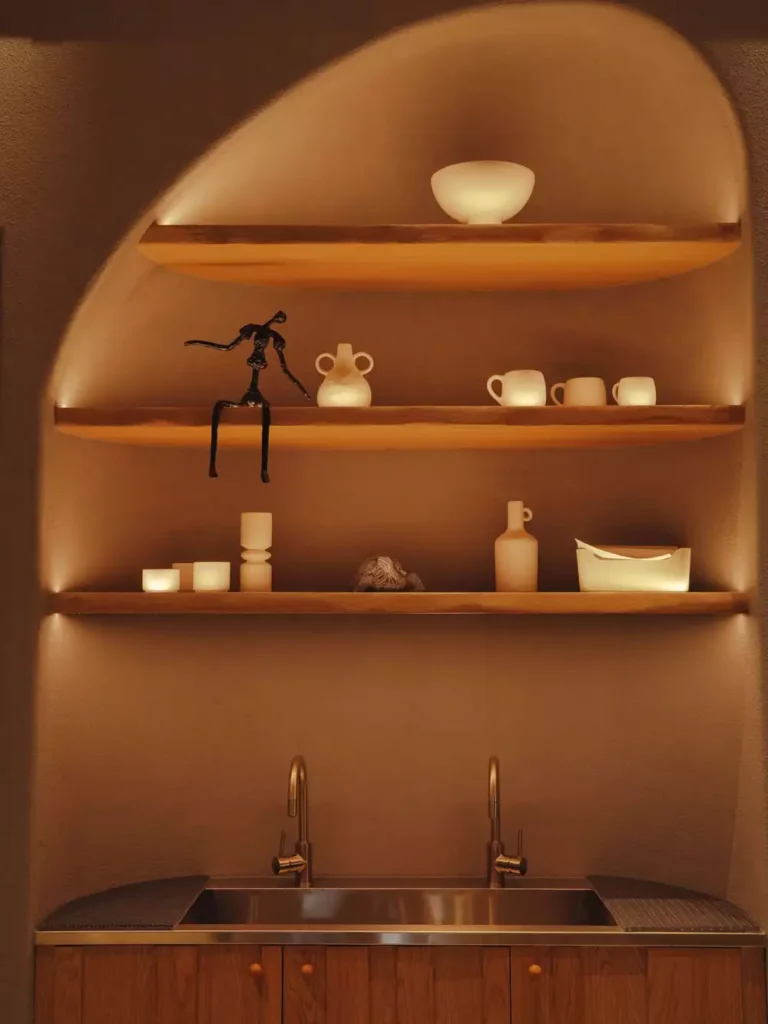 Arched Wall Niche With Wood Shelves Above A Kitchen Sink