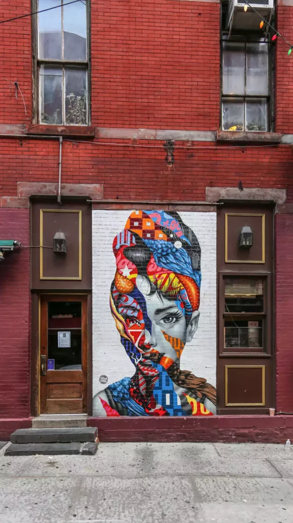 Artistic Portrait Mural Painted On A Red Brick Wall Exterior