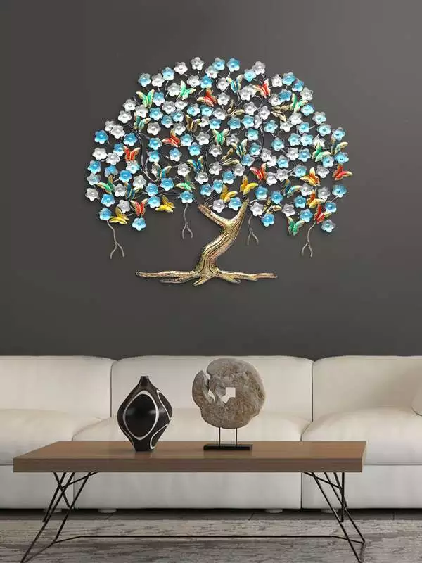 Beaded flower-and-butterfly tree on a charcoal Butterfly Wall behind a sofa