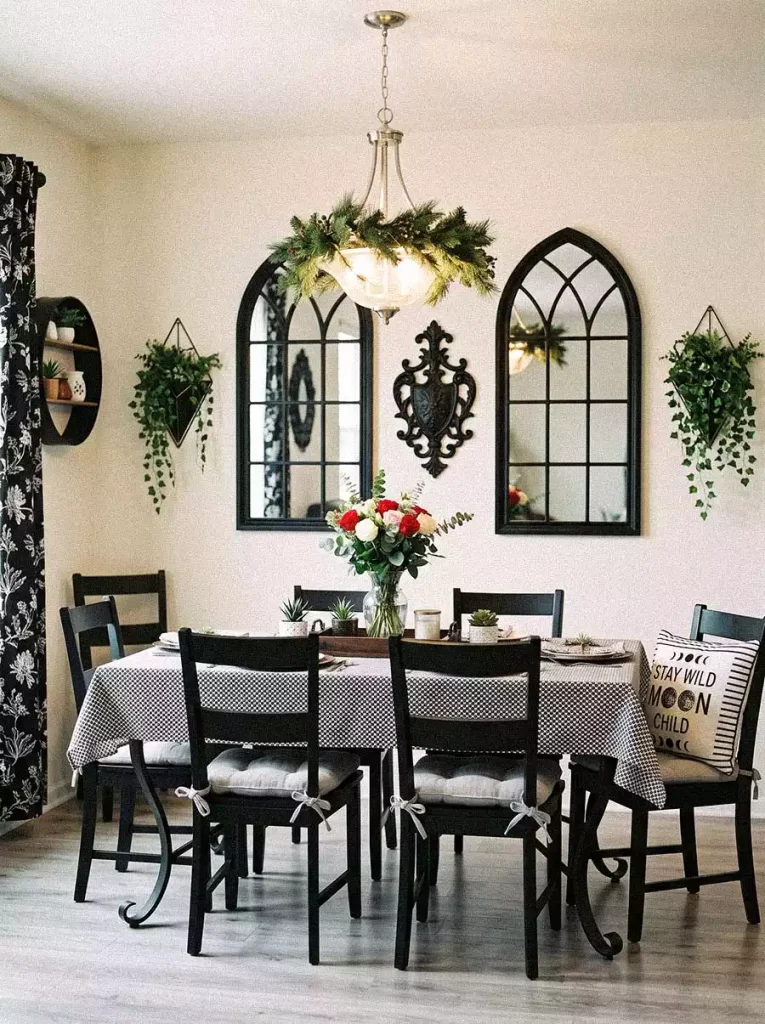 Black arched mirrors, an ornate iron plaque and trailing wall planters make bold Dining Wall Decor above a checkered table