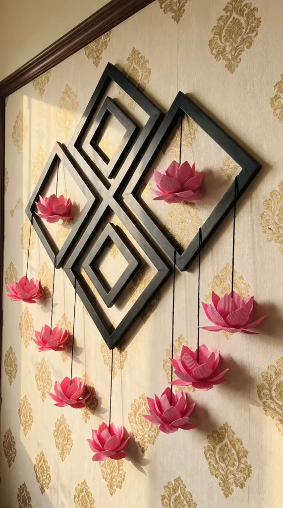 Black geometric frame with hanging paper lotus flowers, a striking Diwali wall decor accent