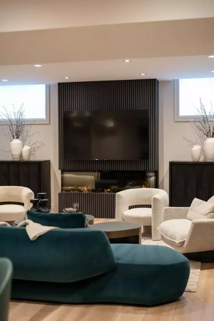 Black Slat TV Wall With Built In Fireplace And Curved Boucle Chairs
