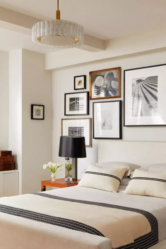 Black and gold framed gallery wall mixing photography and art as gallery style over the bed wall decor