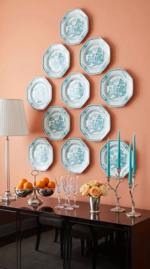 Blue and white chinoiserie plate wall decor arranged in a triangular grid above a console