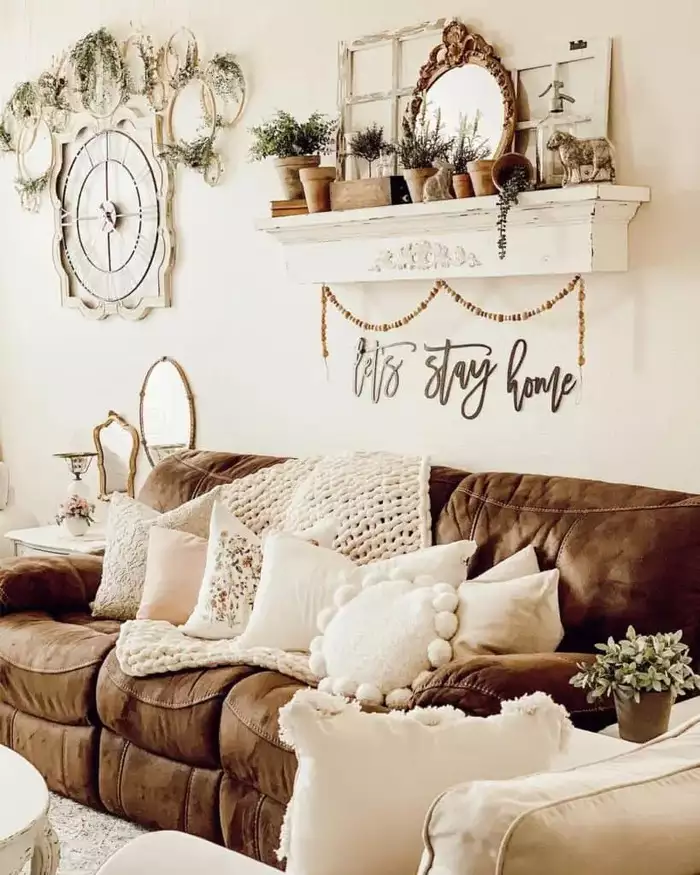 Brown leather sofa under a mantel and lets stay home above sofa wall