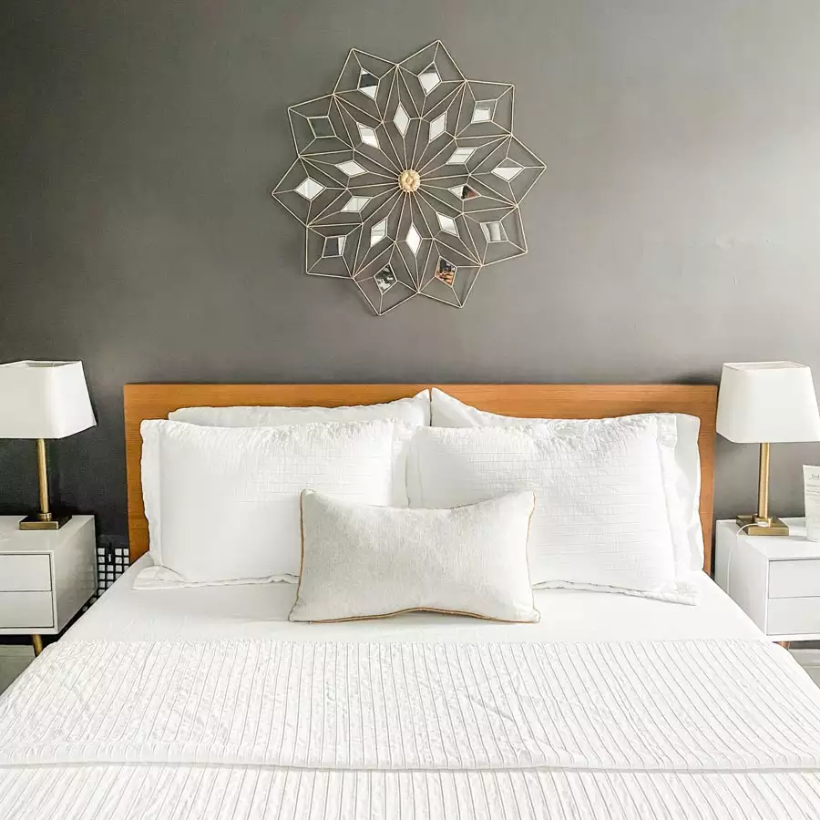 Charcoal Behind The Bed Wall With A Mirrored Starburst Decor Piece