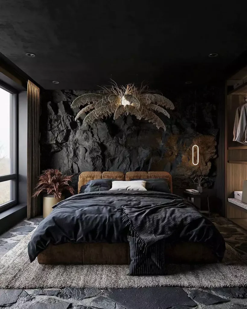 Charcoal-black stone bedroom wall with a dried palm-frond chandelier