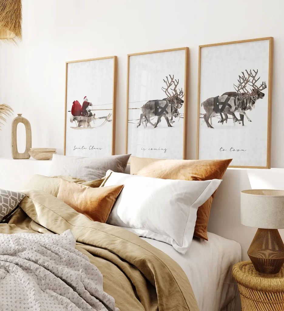 Christmas Wall Art Trio Of Santa's Sleigh And Reindeer Above A Bed With Warm-Toned Pillows