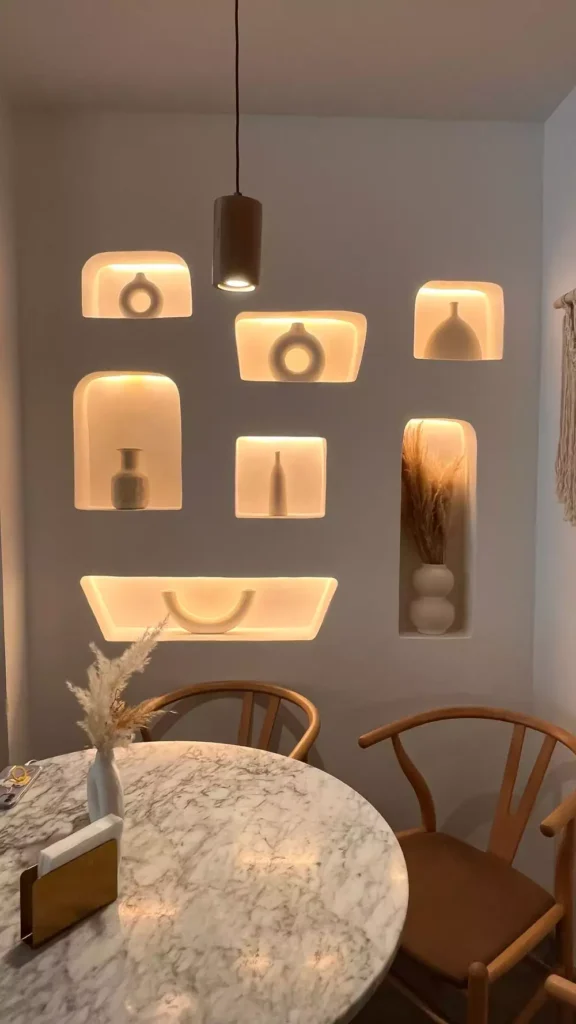 Cluster Of Small Backlit Wall Arches Over A Marble Dining Table