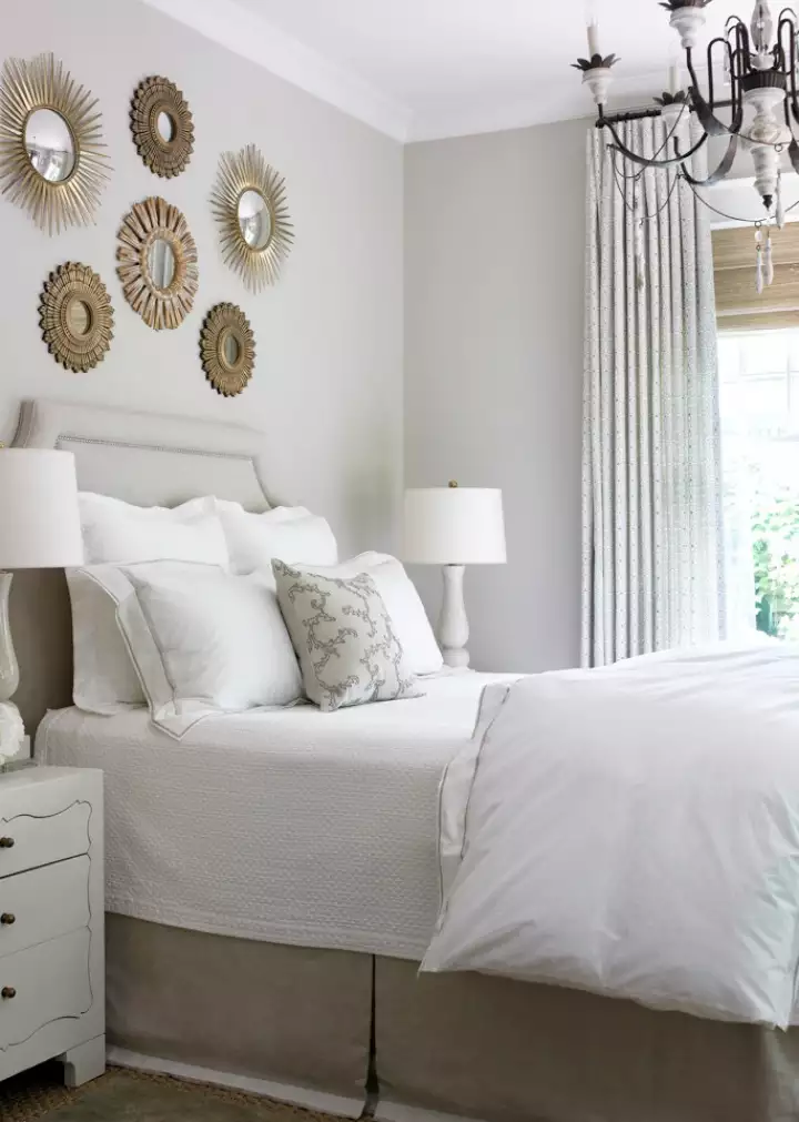 Cluster of small gold sunburst mirrors as glam over the bed wall decor