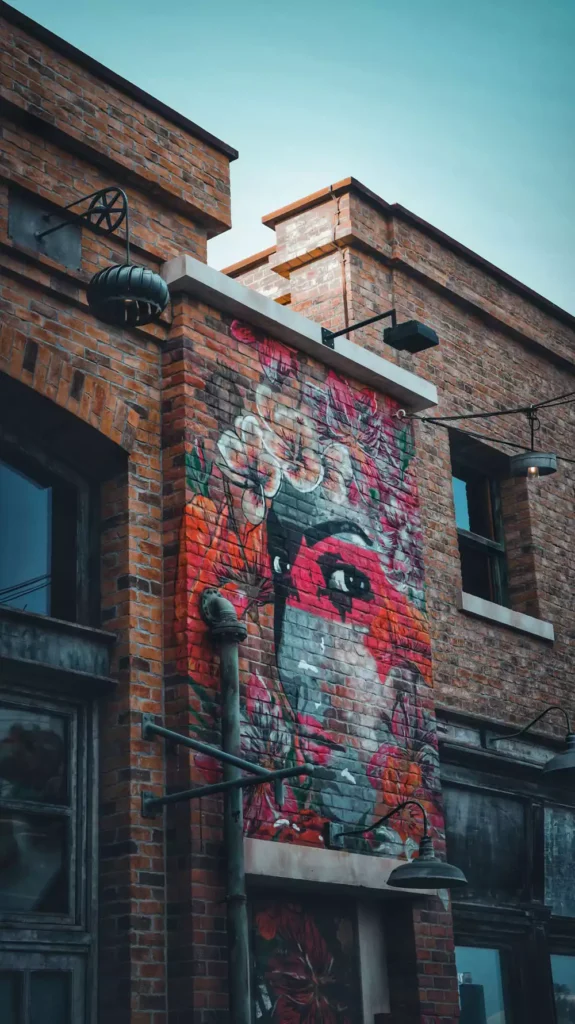 Colorful Floral Mural Painted On An Outdoor Brick Wall Corner