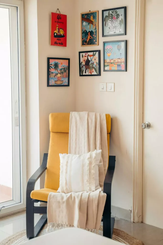 Colorful gallery Corner Wall Decor with tropical art prints, yellow lounge chair and white throw blanket