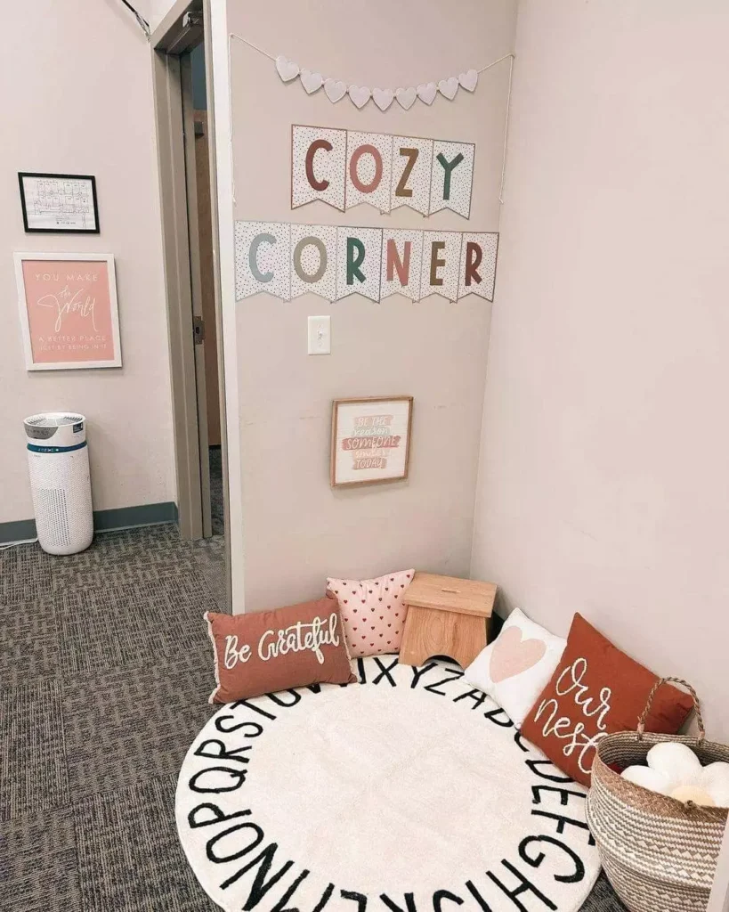 Cozy Corner Wall Decor Above A Round Alphabet Rug And Heart Print Floor Pillows