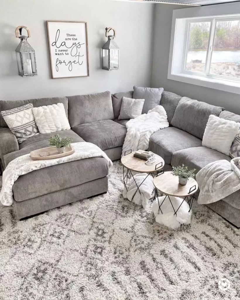 Cozy grey sectional sofa living room decor idea with faux fur throws and patterned rug