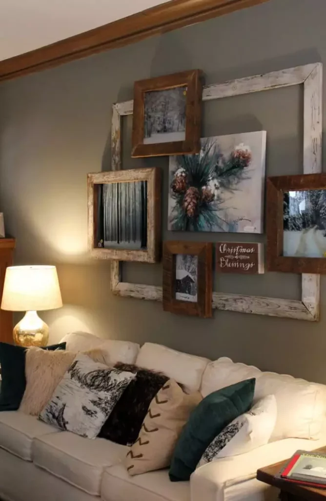 Cream sofa against overlapping rustic frames on a sage above sofa wall