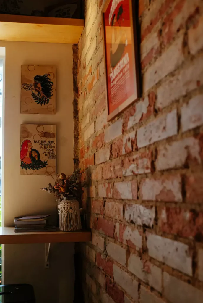 DIY corner wall decor with brick accent wall and macrame wrapped vase with framed Portuguese art panels