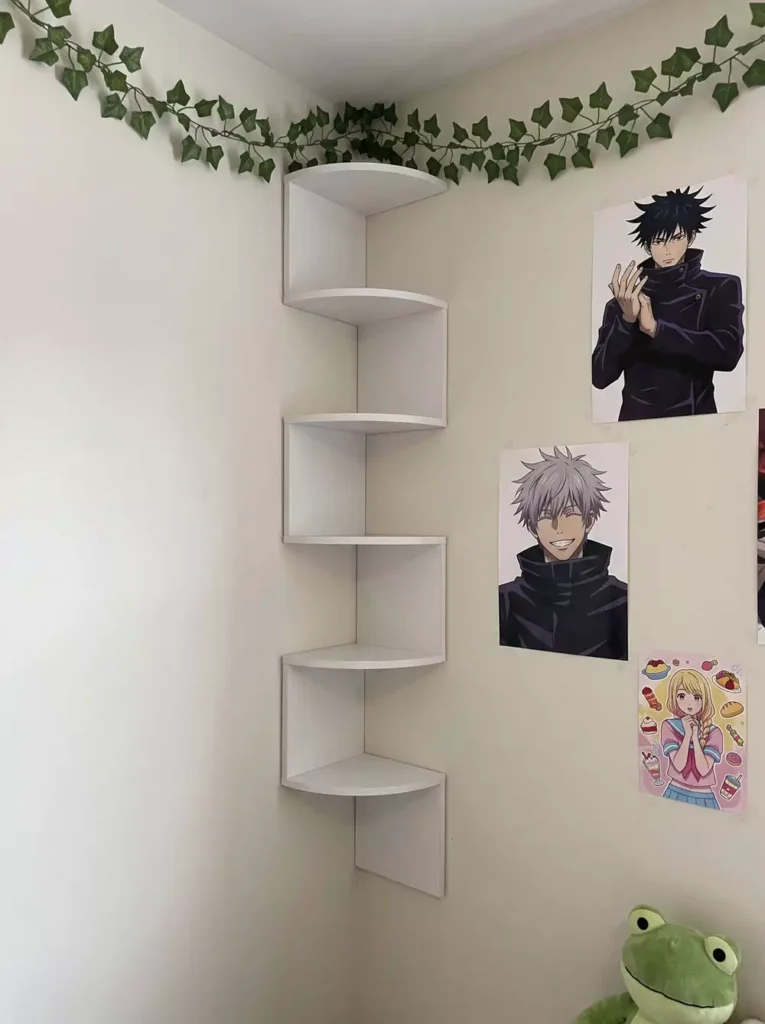 DIY corner wall decor with white zigzag floating corner shelves styled with ivy garland and frog plush in bedroom