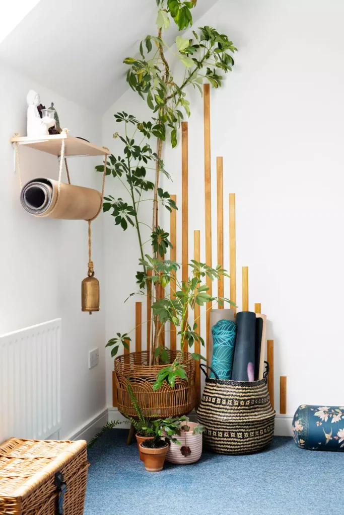 DIY corner wall decor with yoga mat storage rack and wood slat accent with tall indoor plant and woven basket
