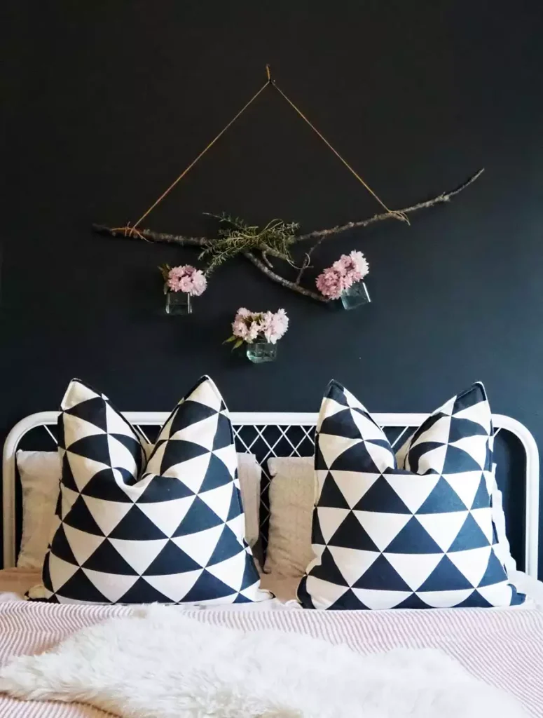 Dark Teal Wall Decor With A Hanging Branch And Floral Accent