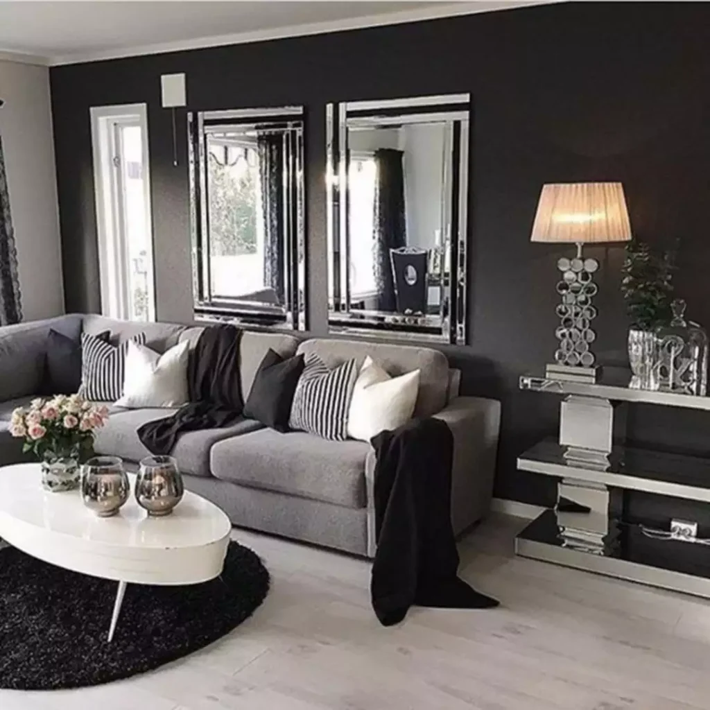 Dark charcoal grey accent wall living room with mirrored console and grey sofa decor idea