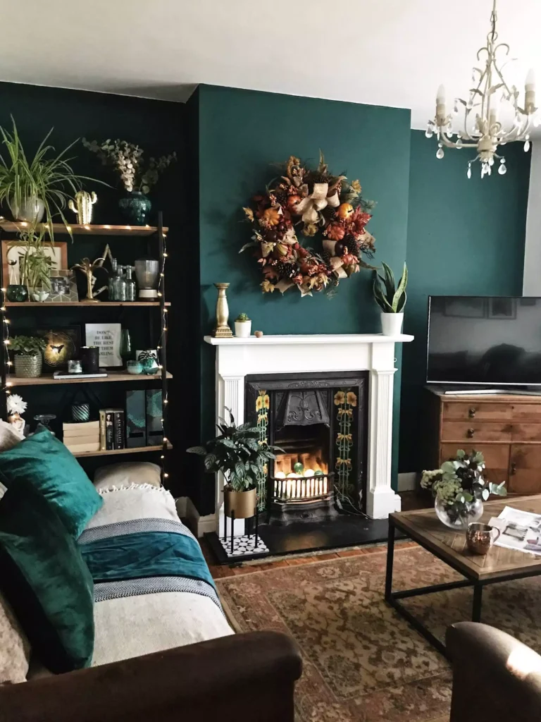 Dark teal living room wall with fireplace and autumn wreath decor