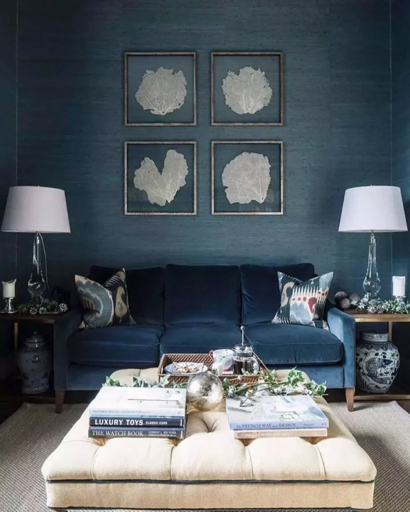 Deep Teal Living Room Wall With Framed Botanical Art Above A Cream Ottoman