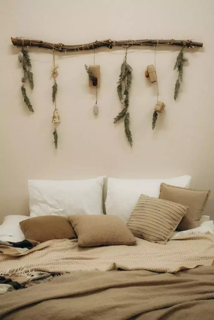 Dried Branch And Greenery Wall Decor Above The Bed