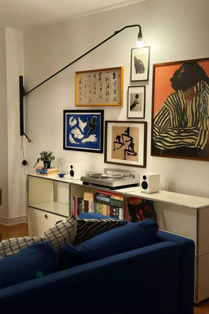 Eclectic Gallery Wall Art Decor Behind Blue Velvet Sofa
