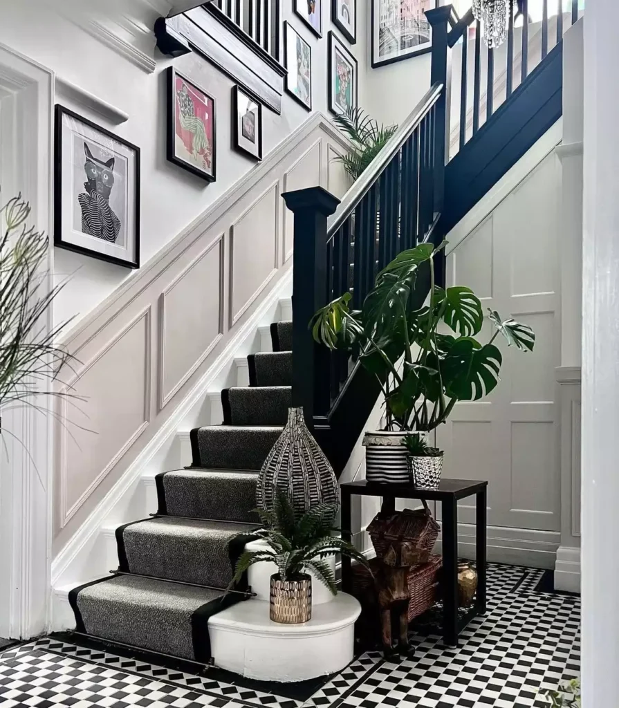Eclectic framed art gallery lining a black and white checkered tile staircase