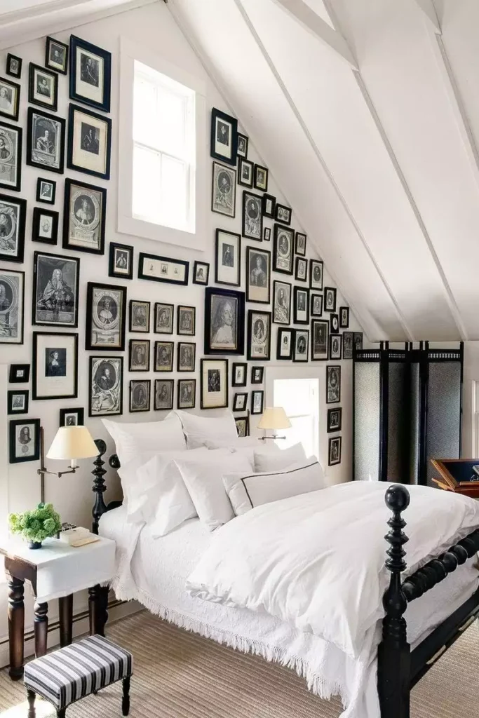Floor to ceiling gallery wall of vintage portraits as dramatic over the bed wall decor