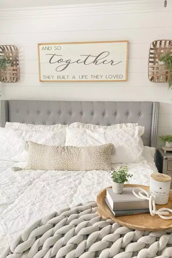 Framed And So Together quote sign flanked by woven basket trays as DIY over the bed wall decor