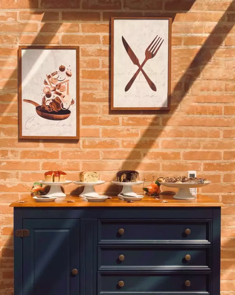 Framed Fork And Knife Prints On A Brick Wall Bring Bold Wall Decor For Kitchen Spaces