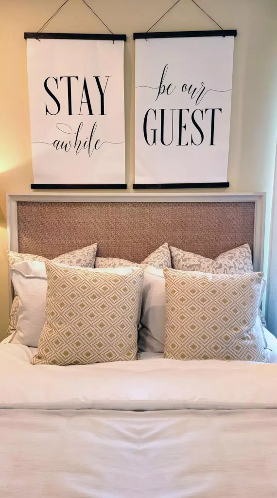 Framed Typography Wall Decor Above A Bed With Patterned Pillows