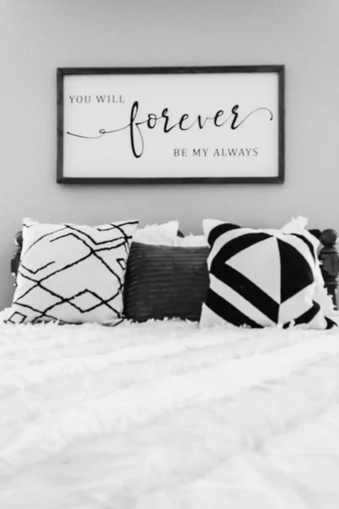 Framed quote sign as sentimental over the bed wall decor in monochrome