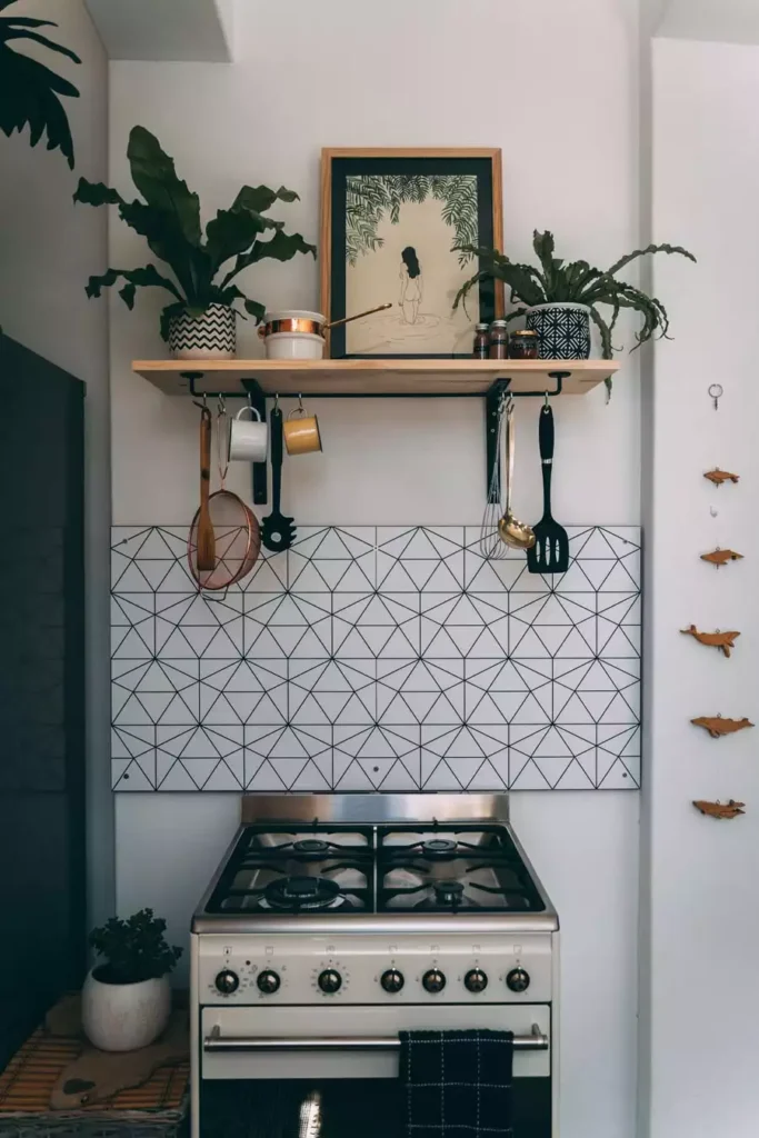 Geometric Tile Backsplash And A Framed Print On A Wood Shelf Bring Boho Kitchen Wall Decor