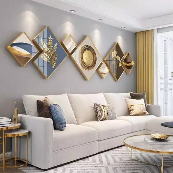 Geometric diamond shaped gold framed art cluster above a living room sofa