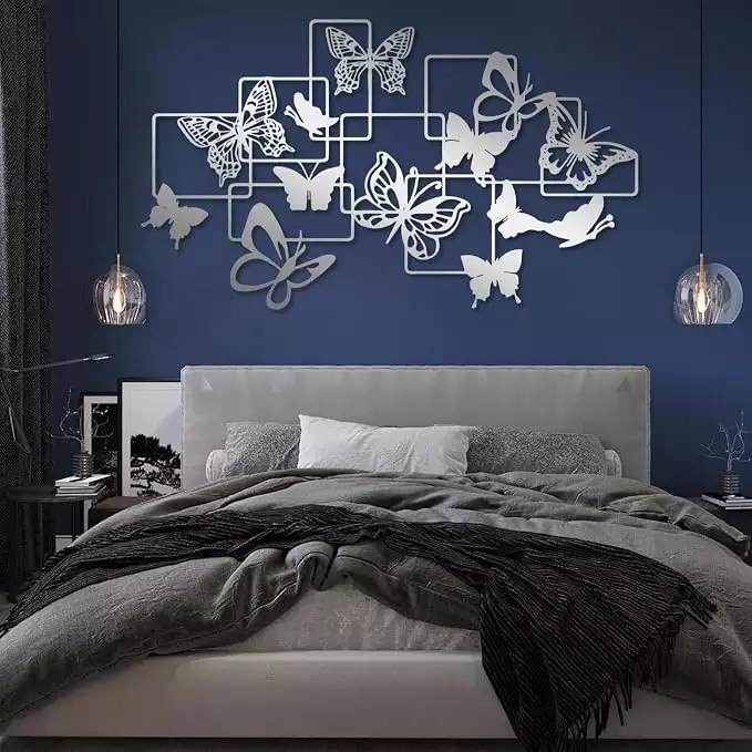 Geometric silver Butterfly Wall panel framed above a navy velvet headboard