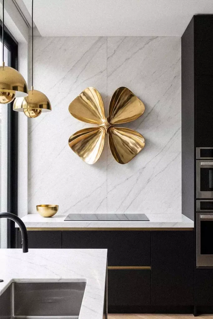 Gold Flower Sculpture On A Marble Wall Adds Luxury Kitchen Wall Decor Above Black Cabinets