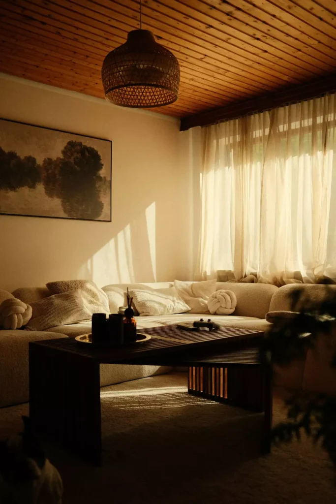 Golden-hour tan wall living room with a wood slat ceiling and a cream boucle sofa
