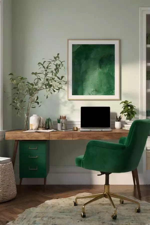 Green wall office accented with a velvet chair and abstract green artwork