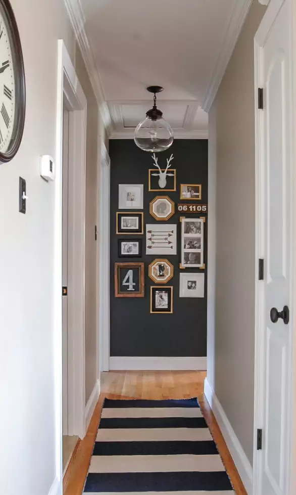 Hallway wall gallery mixing thrifted frames a deer silhouette and mixed art