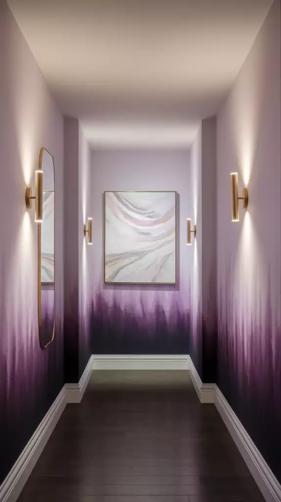 Hallway wall in a purple ombre finish flanked by brass sconces