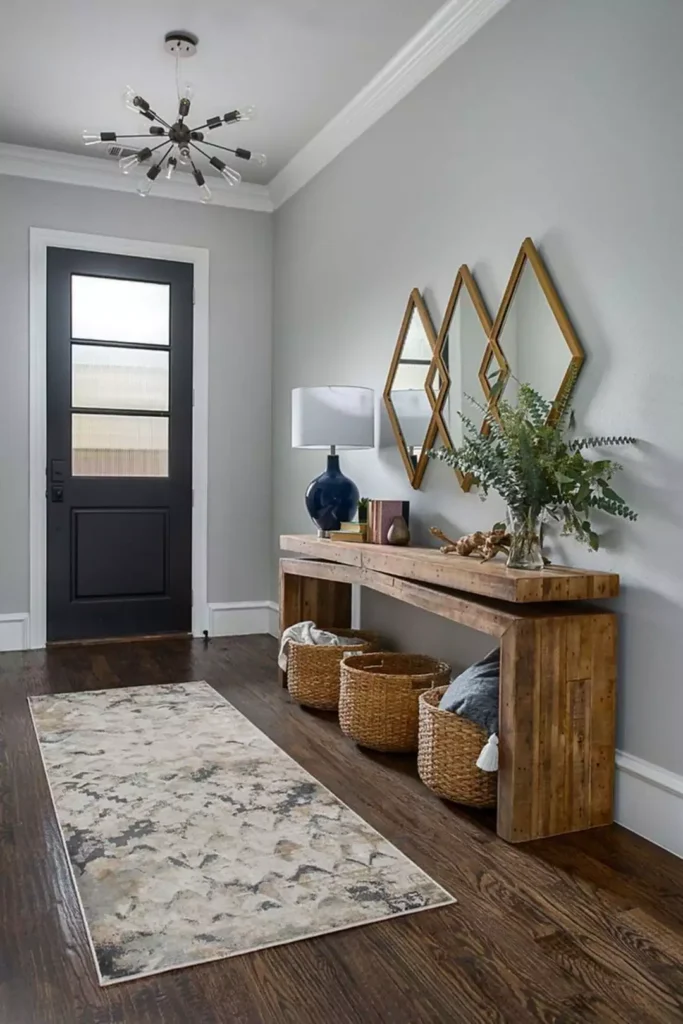 Hallway wall styled with a trio of diamond shaped mirrors over a reclaimed wood console