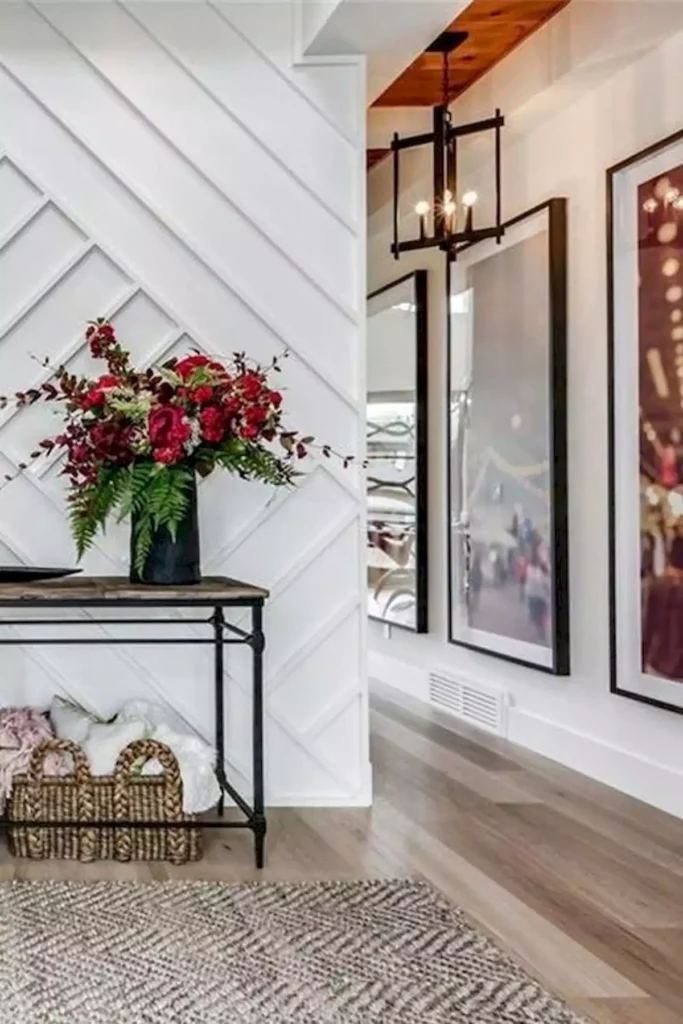 Hallway wall with diagonal white shiplap paneling and a row of oversized framed photos