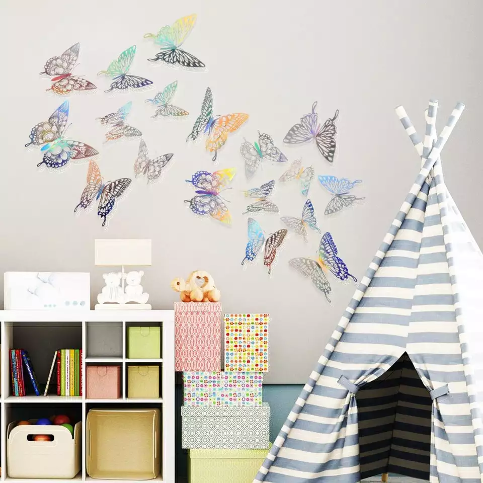 Holographic butterfly stickers forming a playful Butterfly Wall beside a striped teepee