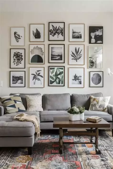 Large wall with a symmetrical gallery wall of botanical and nature prints above a gray sofa
