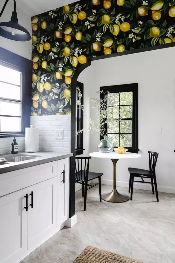 Lemon branch mural wrapping a black arched doorway on a kitchen wall