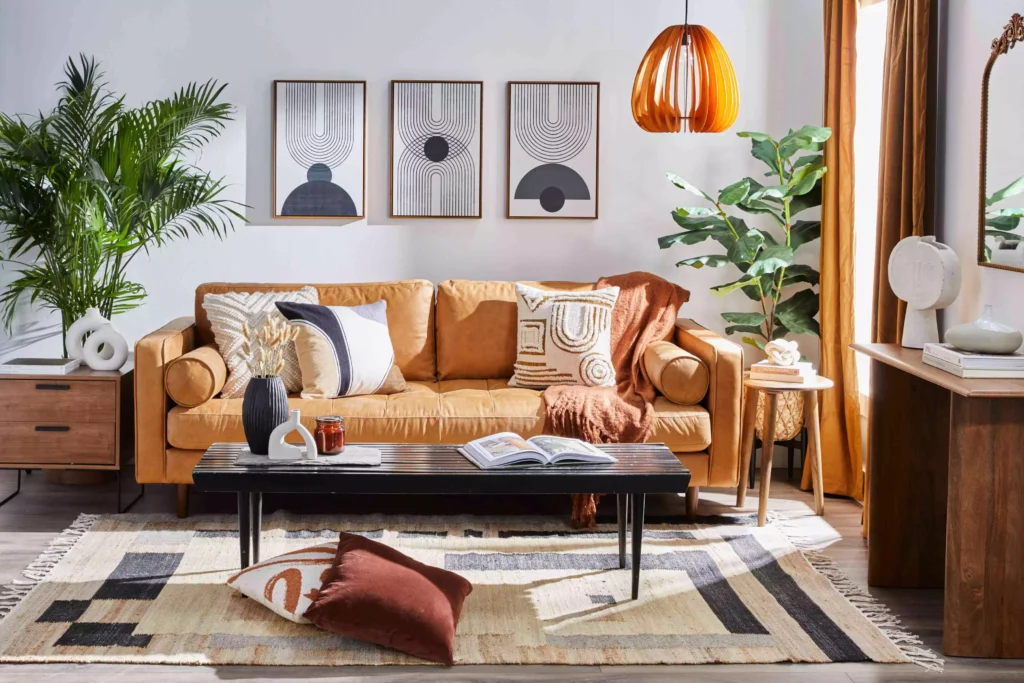 Minimalist line-art gallery wall above mustard sofa in living room